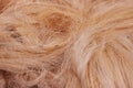 Rough natural raw plant fiber. Detail, closeup. Horizontal. red tone. Wallpaper and background about fabtic manufacture