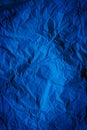 Rough navy blue paper texture. Blue crumpled paper texture and background. Close up view of wrinkled navy blue texture.