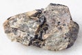 rough Nepheline stone with Ilmenite vein on white