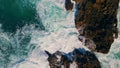 Rough ocean waves breaking of coast cliffs making foam. Aerial view stormy sea Royalty Free Stock Photo