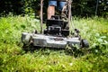 Rough old cottage lawnmower pushes through thick grass and weeds. Royalty Free Stock Photo