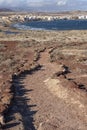 Rough path through the volcanic red ground of Montana Roja, aiming towards El Medano, Tenerife, Canary Islands