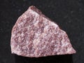 rough pink Quartzite stone on dark background