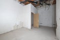 Rough premises with all exposed unfinished electrical piping and cement floors, brick pillars and half-plastered walls, outlet Royalty Free Stock Photo