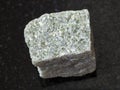 rough quartz-mica schist stone on dark background