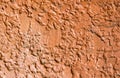 Rough red painted concrete wall. Bright rough plaster photo texture. Royalty Free Stock Photo