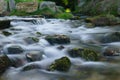 Rough river, water flows among stones. Long exposure Royalty Free Stock Photo