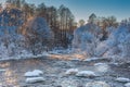 Rough River In Winter With Snow-covered Trees And Steam