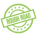 ROUGH ROAD text written on green vintage stamp