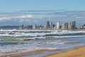 Rough sea against blue cloudy city skyline in Durban Royalty Free Stock Photo