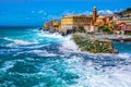 rough sea big waves crash on small port of Nervi in Genoa in Italian Riviera of liguria in beautiful sunny day