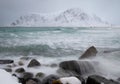 Rough sea and distant snow covered island at Skagsanden beach, Norway