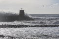 Rough sea on the pier of Recco with the lighthouse, Genoa province, Italy Royalty Free Stock Photo