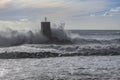 Rough sea on the pier of Recco with the lighthouse, Genoa province, Italy Royalty Free Stock Photo