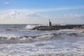 Rough sea on the pier of Recco with the lighthouse, Genoa province, Italy Royalty Free Stock Photo