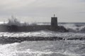 Rough sea on the pier of Recco with the lighthouse, Genoa province, Italy Royalty Free Stock Photo