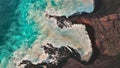 Rough sea seen from the air next to a rocky cliff Royalty Free Stock Photo