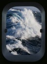 Rough sea through a ships porthole Royalty Free Stock Photo