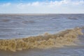 The rough sea - Storm surge with waves, foam and muddy water