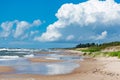 Rough sea with waves, cloudy sky, sandy beach and dunes Royalty Free Stock Photo