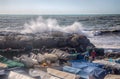 Rough sea waves crashing over a pier in the city of Genoa Genova, mediterranean sea, ligurian coast, Italy.