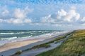 Rough sea with waves and sand beach in autumn or winter Royalty Free Stock Photo