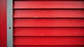 Rough, slightly pitted red aluminum siding with a weathered gray frame , construction, building, surface Royalty Free Stock Photo
