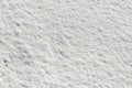 Rough snow texture in sunny weather, winter background Royalty Free Stock Photo