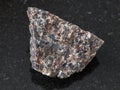 rough spreusteined urtite stone on dark Royalty Free Stock Photo