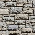 Rough stone bricks in a rectangular pattern create a textured wall. The stones vary in Royalty Free Stock Photo