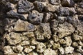 Rough stone solid wall closeup photo. Stone wall texture. Rustic stone wall of ancient building. Royalty Free Stock Photo