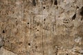 Rough stone surface with carved inscriptions resembling ancient alphabets or typefaces, possibly Georgian script Royalty Free Stock Photo