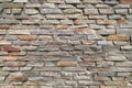 Rough stone wall made of ceramic tiles of different sizes and colors. Royalty Free Stock Photo