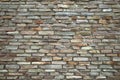 Rough stone wall made of ceramic tiles of different sizes and colors. Royalty Free Stock Photo