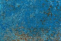 Rough surface of perforated painted metal plate. Textured background. Blank for design. Underlay or undercoat Royalty Free Stock Photo