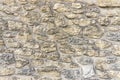 Rough surface of random pattern rastic of brown and light yellow color natural free form sand stone cladding on the concrete wall Royalty Free Stock Photo