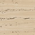 Rough surface of travertine stone, featuring a sandy beige color with natural Royalty Free Stock Photo