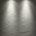 Rough-textured, gray plaster wall illuminated by two overhead lights. The surface Royalty Free Stock Photo