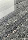 Rough-textured stone surface featuring a mix of black, gray, and white speckles. The Royalty Free Stock Photo
