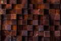 Rough textured surface of an old retro vintage wall made of square blocks of wood of different sizes. Background