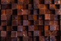 Rough textured surface of an old retro vintage wall made of square blocks of wood of different sizes. Background