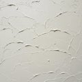 Rough-textured wall surface with an irregular plaster finish. The white plaster is Royalty Free Stock Photo