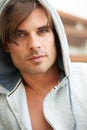 Rough and tough. Portrait of a tough looking young man wearing a hooded jumper. Royalty Free Stock Photo