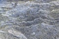 Rough, uneven, irregular granite stone surface. Natural textured relief grey background.