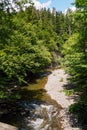 Rough water in the mountains, water flows over the rocks, forest, nature, mountains, waterfall, background Royalty Free Stock Photo