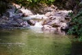 Rough water in the mountains, water flows over the rocks, forest, nature, mountains, waterfall, background Royalty Free Stock Photo