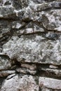 Rough weathered ancient mayan stone wall surface texture close up