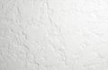Rough white concrete wall texture shows uneven plaster layers. This textured surface offers a stark, minimal backdrop for design Royalty Free Stock Photo