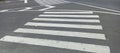 Rough white lines on zebra crossing at intersection Royalty Free Stock Photo