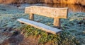 Rough wooden bench in the early morning sun Royalty Free Stock Photo